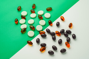 Many different tablet pills on color background, flat lay, with copy space.