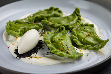 delicious Ukrainian dumplings with sauce on a plate.

