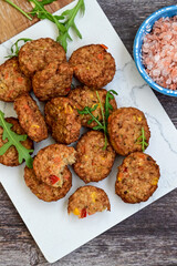 Home made  oven baked  mini  Chicken and vegetable meatballs   on  wooden background