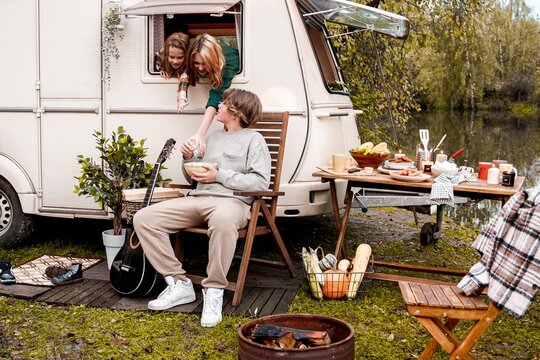 Children,family,brother sister traveling in camper,house on wheels. Trailer motor home.Looking in window. Funny road travel.Campsite van overnight.Wanderlust vacation,weekend.Girl,guy,happy adventure