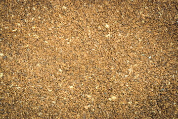 The grains of ground black coffee are very close. Close up ground coffee background. Brown coffee powder texture extreme closeup photo