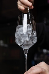 the bartender prepares a delicious alcoholic cocktail	