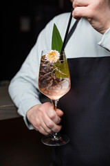 the bartender prepares a delicious alcoholic cocktail	