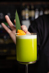 the bartender prepares a delicious alcoholic cocktail	