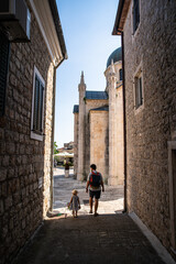 Fototapeta na wymiar Father and little daughter walking on narrow streets of Mediterranean town. Herceg Novi, Montenegro.