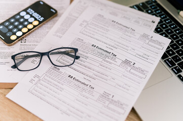 tax forms 2023 with glasses on the office table