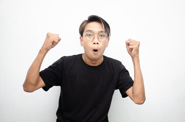 asian man with peek a boo hair dancing hapily with yes hand gesture raising fist celebrating good news isolated over white background. People, joy, fun and happiness concept. 