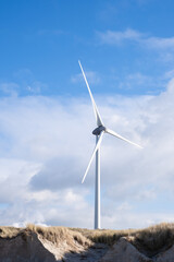 Wind Turbine Against Cloudy Blue Sky Dune beach Landscape