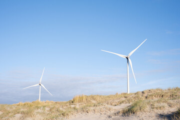 Wind Turbine Against Cloudy Blue Sky Dune beach Landscape
