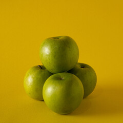 Fresh, healthy four apples packed with vitamins exist in balance forming a pyramid