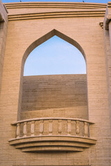 arched balcony on the old amphitheatre made of beautiful soft yellow brick in a perfect contrast to blue sky 