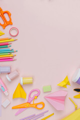 Pink pastel background with various colorful material for creativity and art activity.  Stationery...