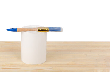 white paint with a brush on a wooden background with texture