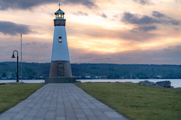Sunset photo of the Myers Point Lighthouse at Myers Park in Lansing NY, Tompkins County. The lighthouse is situated on the shore of Cayuga Lake, near Ithaca New York.	