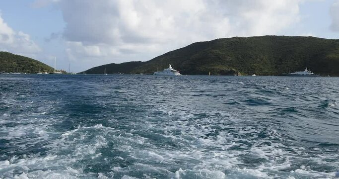 Virgin Gorda Caribbean island bay luxury yacht POV. Commonwealth of the United Kingdom, British Virgin Islands. Cruise ship vacation destination. Resort, yacht, sailboat harbor and marina.