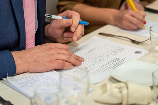 D&eacute;tail Gros plan d'un jury de concours de cuisine entrain de noter.