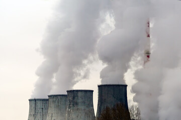 Large cooling tower pipes emit large amounts of steam into the atmosphere