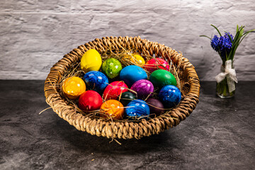round easter basket with colorful easter eggs