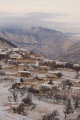 The aul is located on a mountainside in Dagestan and is covered with snow.