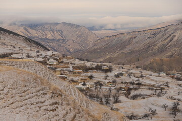 The aul is located on a mountainside in Dagestan and is covered with snow.