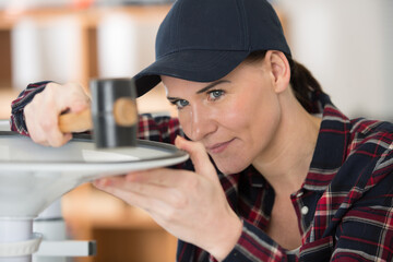 female contractor repairing furniture