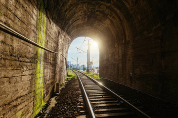 Fototapeta na wymiar Sunset light at the end of railroad tunnel