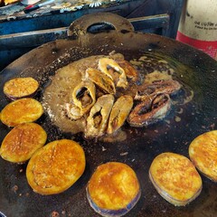 Ilish Fry - Fresh Ilish fish on a big fry pan getting cooked on a hotel at the Mawa Ghat near Padma...