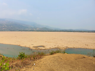 Jadukata River - a beautiful river near the India border during the winter season with the hills of Meghalaya on the back in Sylhet, Bangladesh.