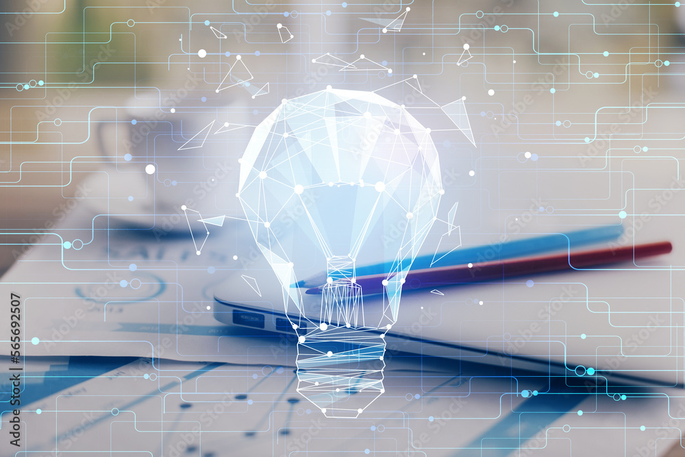 Poster computer on desktop in office with bulb icon hologram. double exposure. concept of idea.