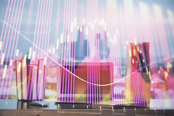 Obraz premium Stock market graph on background with desk and personal computer. Multi exposure. Concept of financial analysis.