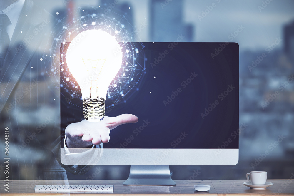 Poster computer on desktop in office with bulb icon hologram. multi exposure. concept of idea.