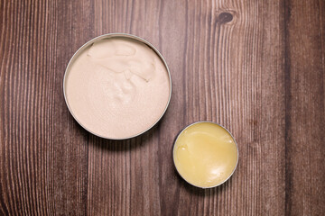 Men's beard balm, wax on wooden background.