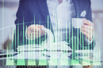 Double exposure of businessman with coffee with stock market forex chart.