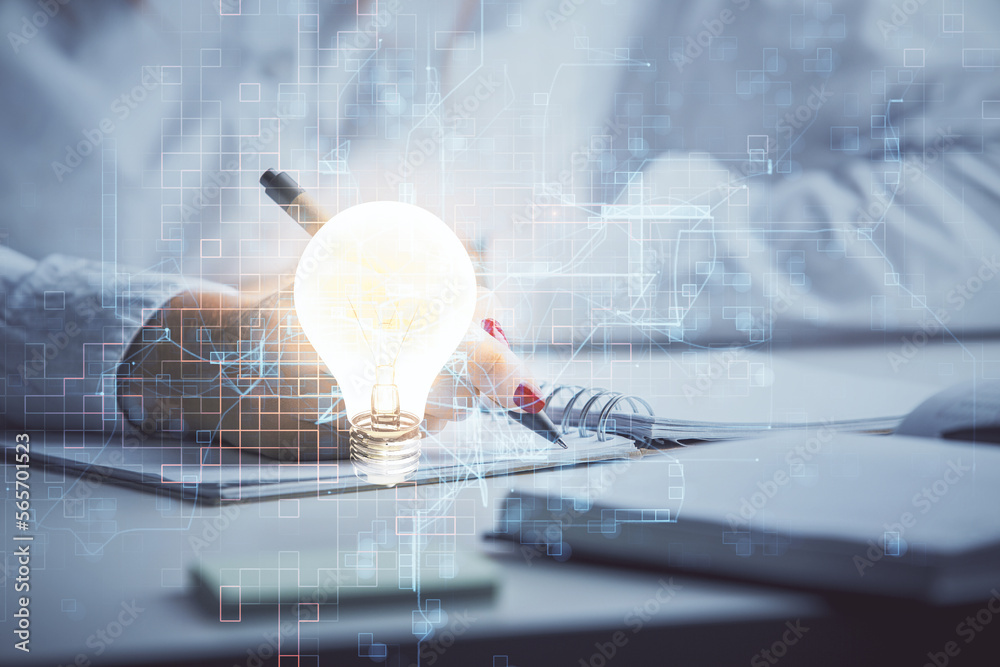 Poster bulb hologram over hands taking notes background. concept of idea. double exposure