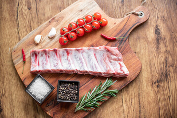 raw pork ribs on wooden background