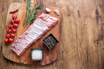 raw pork ribs on wooden background with copy space for your text