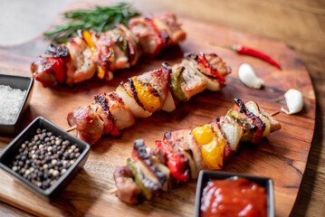 Meat kebabs with grilled vegetables on a rustic background