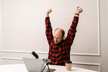 man stretching at remote workplace