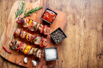 Meat kebabs with grilled vegetables on a rustic background