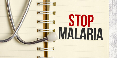 Stethoscope, paper with word stop malaria . Medical Concept