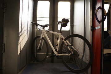 Fototapeta na wymiar Bicycle standing in the vestibule. Tourism with a bicycle. Transport the bike on the train. Travel with a bike.