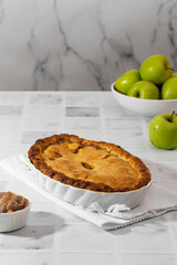 apple pie on white kitchen table