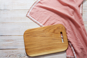 empty wooden board for food and tablecloth on wooden background top view