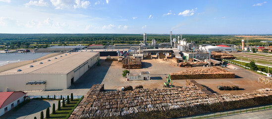 Aerial view of wood processing factory with stacks of lumber at plant manufacturing yard