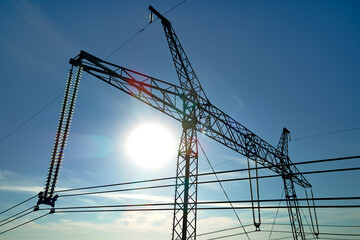 High voltage tower with electric power lines transfening electrical energy through cable wires