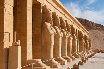 Luxor, Egypt. Pharaoh Hatshepsut mortuary temple ancient architecture with stone statues.