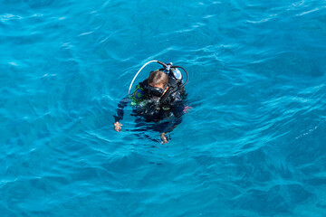 Egypt - diver with scuba swimming in Red sea