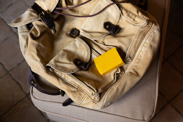  Yellow piece of wax on the backpack.. Canvas backpack after laundering is prepared for waxing with natural beeswax for dirt-repellent and waterproof impregnation.
