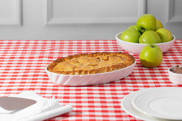 apple pie on a red checkered tablecloth