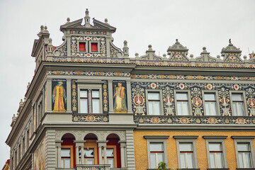Fototapeta na wymiar Beautifully decorated building in Prague. We see frescoes, ornaments and a religious theme.